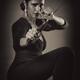 Young woman with knife in defending pose Black and white... (thumbnail)