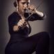 Young woman with knife in defending pose... (thumbnail)