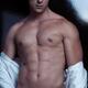 Portrait of muscular sexy man taking off his shirt... (thumbnail)