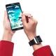Person with Samsung Galaxy Note III smartphone and Galaxy Gear watch... (thumbnail)