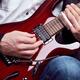 Person playing electric guitar with slide... (thumbnail)