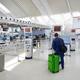 Person checking in at airport... (thumbnail)