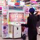 Girl playing dance station slot machine at arcade... (thumbnail)