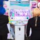 Girls playing dance station slot machine at arcade... (thumbnail)