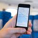 Person using iPhone GPS on a train... (thumbnail)