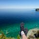 Legs of a person sitting on a cliff of Georgian Bay Bruce Peninsula in... (thumbnail)