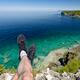 Legs of a person sitting on a cliff of Georgian Bay in Canada... (thumbnail)