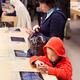People trying new iPhone at Apple store in Japan... (thumbnail)