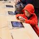 Child using iPhone at Apple store... (thumbnail)