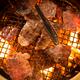 Closeup of Japanese beef being grilled on fire... (thumbnail)
