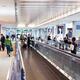 People on moving walkway at an airport... (thumbnail)