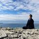 Person meditating on a shore of a lake... (thumbnail)