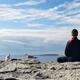 Person meditating on a shore of a lake with seagulls... (thumbnail)