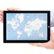 Person holding Microsoft Surface tablet with world map on display... (thumbnail)