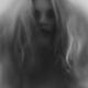Beautiful young woman face behind hazy glass... (thumbnail)