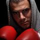 Dramatic portrait of man wearing boxing gloves... (thumbnail)