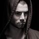 Dramatic portrait of a man in a hoodie with serious expression on his... (thumbnail)