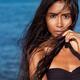 Beautiful woman portrait with long wet dark hair against blue sea wate... (thumbnail)