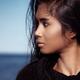 Young woman with dark hair portrait at the beach... (thumbnail)