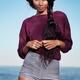 Young woman in striped shorts at the beach... (thumbnail)