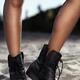 Woman legs in black boots at the beach... (thumbnail)