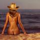 Naked woman sitting at the beach on sand... (thumbnail)