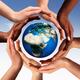 Multiracial hands making a circle together around the world globe... (thumbnail)