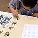 Shaolin martial arts school student practicing Chinese calligraphy... (thumbnail)