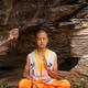 Shaolin martial arts school student meditating under rocks... (thumbnail)