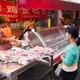 Woman selling chickens at the market... (thumbnail)