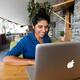 Young smiling woman using Apple laptop... (thumbnail)
