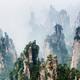 Mountain spires rising from fog at Zhangjiajie National Forest Park... (thumbnail)