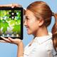 Smiling young woman looking at Apple iPad tablet... (thumbnail)
