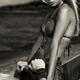 Sensual dramatic black and white portrait of a sexy couple at a sandy... (thumbnail)