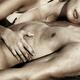 Sensual closeup of a couple lying together on sand... (thumbnail)