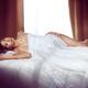 Beautiful young asian woman lting naked in bed covered with white shee... (thumbnail)