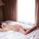 Beautiful nude woman sleeping in bed by the window... (thumbnail)