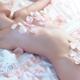 Beautiful nude woman lying in bed with pink rose petals on her body... (thumbnail)