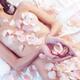 Beautiful nude asian woman with rose petals on her body... (thumbnail)