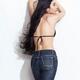 Asian woman in jeans with long hair leaning against wall... (thumbnail)