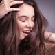 Smiling young woman with long brown hair... (thumbnail)