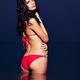 Beautiful glamorous woman in red bikini standing in water at night... (thumbnail)
