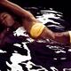 African american woman in bikini lying in black water... (thumbnail)