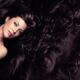 Beauty portrait of woman face surrounded by long luscious brown hair... (thumbnail)