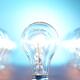 Illuminated light bulbs on bright blue background... (thumbnail)