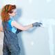 Woman construction worker patching up drywall... (thumbnail)