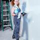 Portrait of smiling woman with trowel and putty knife mudding drywall... (thumbnail)