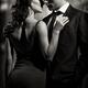 Couple kissing in front of window Black and white... (thumbnail)
