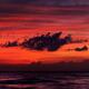 Dark dramatic clouds backlit by beautiful red sunset sky... (thumbnail)