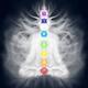 Woman meditating in lotus pose silhouette with Chakras and energy flow... (thumbnail)